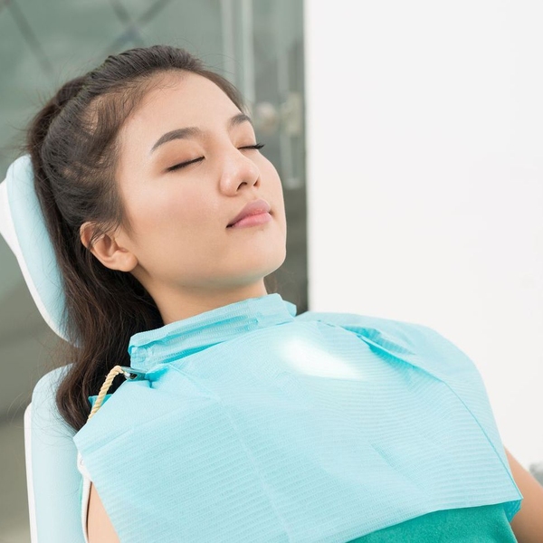 Young relaxed woman resting in dentist's chair
